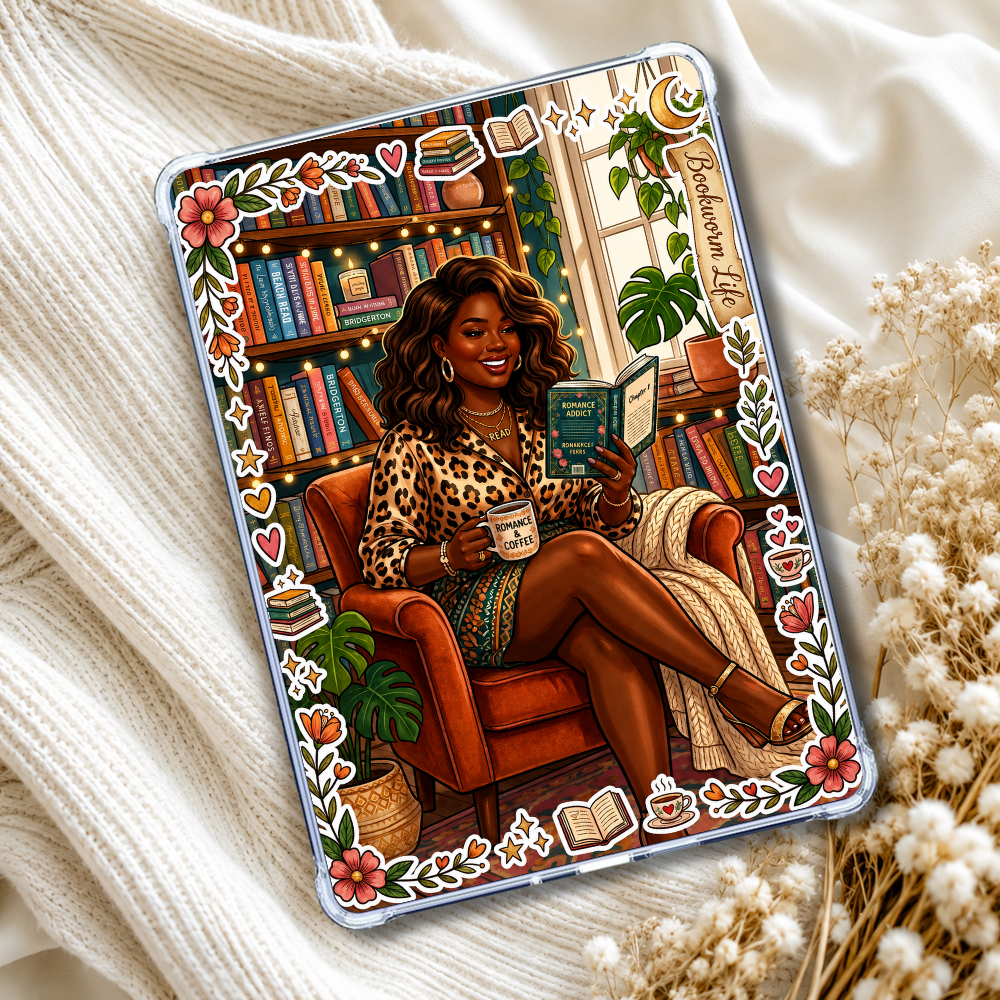 A clear iPad case featuring a colorful illustration of a woman in a leopard-print top sitting in an orange armchair and reading a book, surrounded by bookshelves, plants, and decorative motifs. The case is styled on a cream knit blanket with dried flowers.